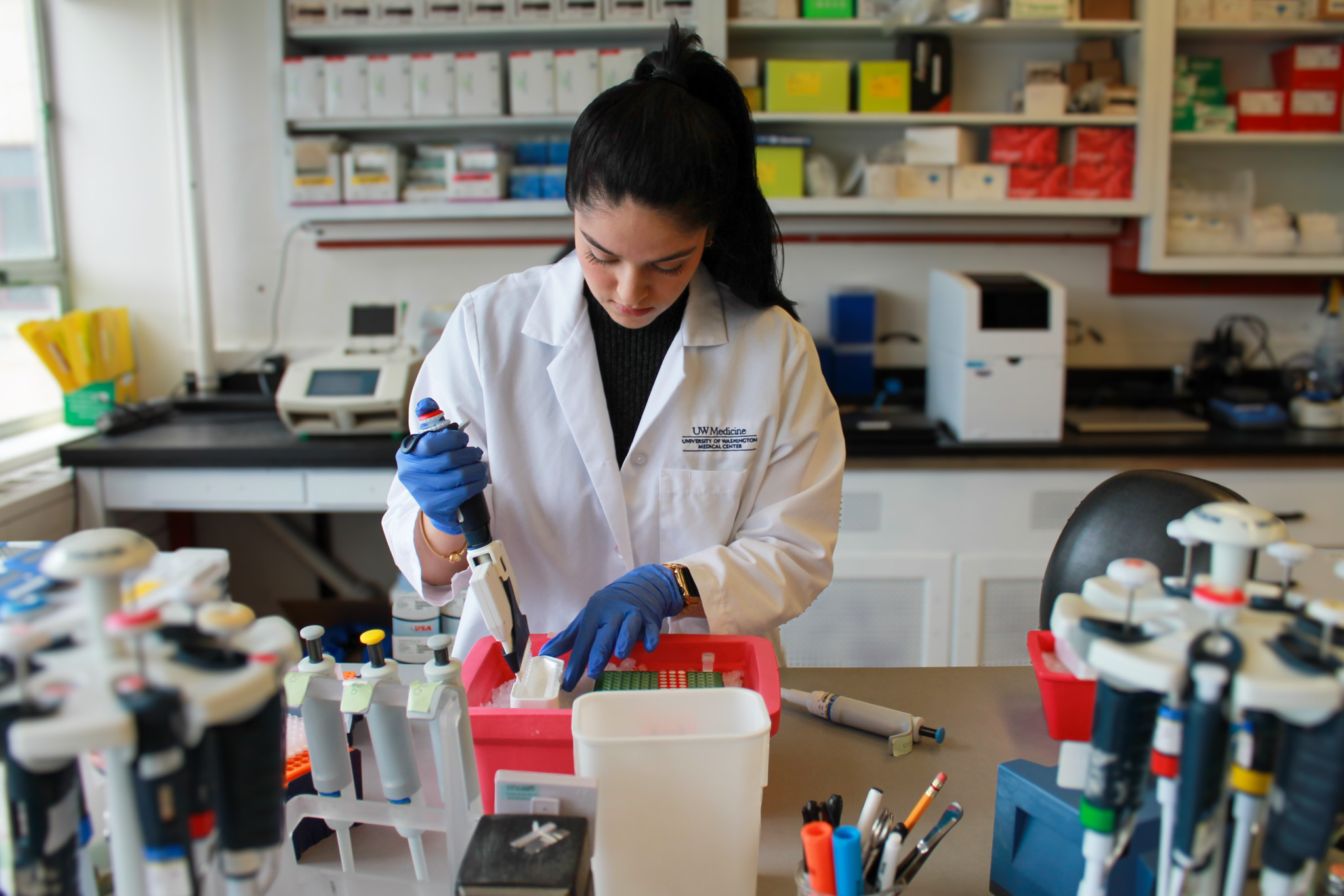 research staff member pipetting in a lab