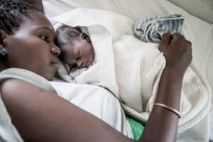 A mother cuddles a newborn