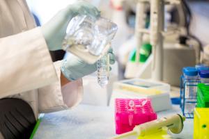 Close up of hands working with lab equipment